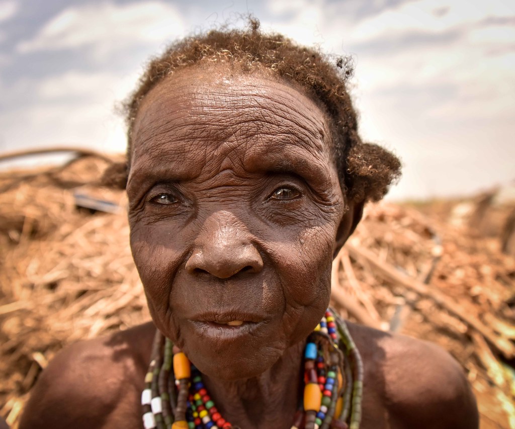 An older woman photographed outside her home